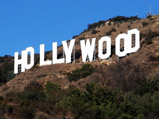 It's fitting that the Hollywood Sign, the worldwide symbol of the entertainment industry, was conceived as an outdoor ad campaign for a suburban housing development called Hollywoodland.