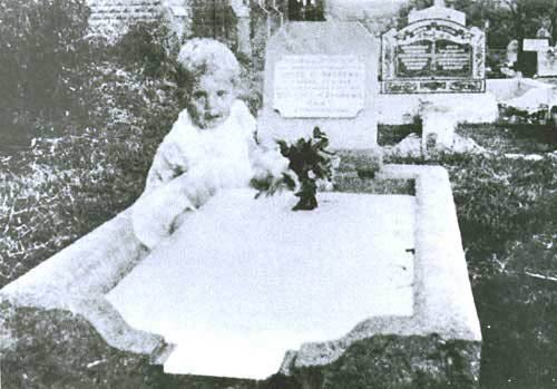 Mrs. Andrews was taking a picture of her daughter's grave and the figure of a ghost child appears.